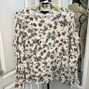 Size small - cream colored shirt with ruffle sleeve, floral, print all over